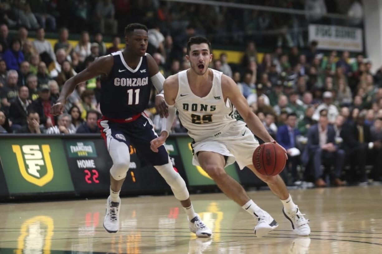 San Francisco guard Jordan Ratinho (25) drives against Gonzaga guard Joel Ayayi (11) during the first half of an NCAA college basketball game in San Francisco, Saturday, Feb. 1, 2020.