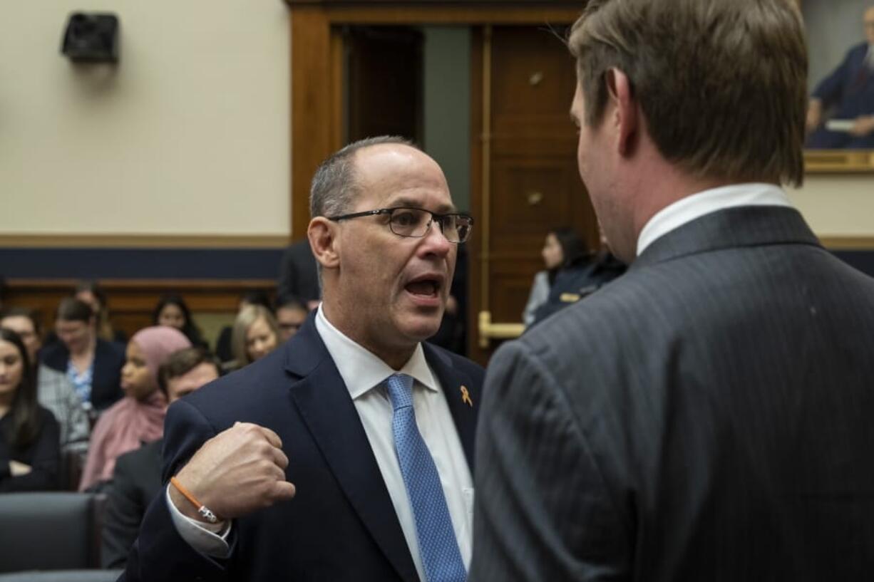 Fred Guttenberg, left, whose daughter was killed in the Parkland, Fla., school shooting, talks with Rep. Eric Swalwell, D-Calif., before FBI Director Christopher Wray testifies during an oversight hearing of the House Judiciary Committee, on Capitol Hill, Wednesday, Feb. 5, 2020 in Washington.