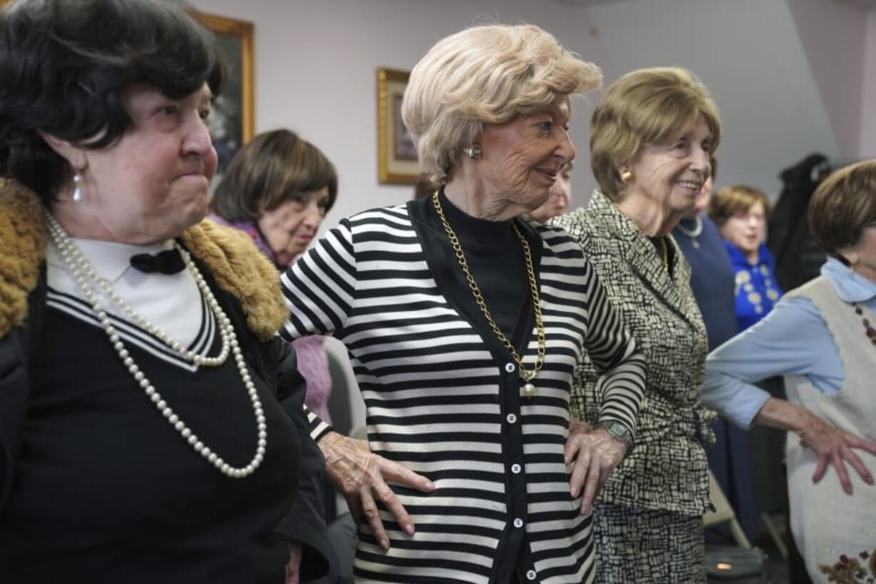 In this Jan. 22, 2020 photo, Dolly Rabinowitz, center, exercises with other Holocaust survivors at Nachas Health and Family Network in the Brooklyn borough New York. The community center provides survivors with meals, legal assistance, exercise classes and social events.