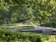 This photo provided by the New York Botanical Garden shows the Native Plant Garden at the NYBG in New York. Sustainability and resilience were important considerations for landscape architect Sheila Brady&#039;s design of the garden. Storm water captured on site feeds the central water feature. Black locust, considered invasive in parts of the US, was used to construct the wooden promenade. The regionally native plants provide invaluable food and shelter for native birds and butterflies at risk from climate change and other anthropogenic stresses.