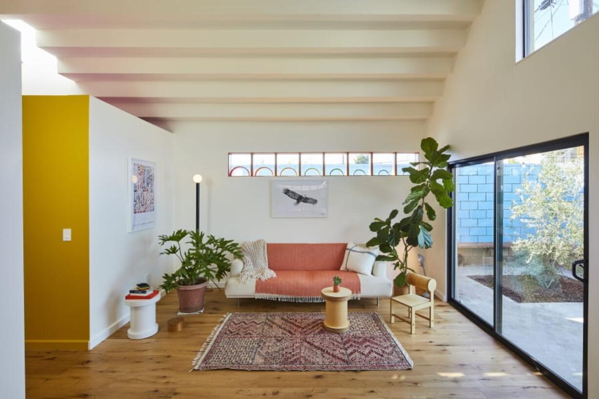 This undated photo shows a converted garage project by Bunch Design in the Highland Park area of Los Angeles, Calif. In this converted garage project, long clerestory windows were placed high on the walls of a small living room. Afternoon light streams through a west-facing skylight, and a stepped ceiling creates more interesting light plays. &quot;The house sits in the middle of a dense residential neighborhood,&quot; says Bo Sundius of Bunch Design, &quot;yet it feels airy and open.&quot; Sundius says they always think of how sun and light moving across space can be utilized to connect interiors to the outside world.