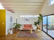 This undated photo shows a converted garage project by Bunch Design in the Highland Park area of Los Angeles, Calif. In this converted garage project, long clerestory windows were placed high on the walls of a small living room. Afternoon light streams through a west-facing skylight, and a stepped ceiling creates more interesting light plays. &quot;The house sits in the middle of a dense residential neighborhood,&quot; says Bo Sundius of Bunch Design, &quot;yet it feels airy and open.&quot; Sundius says they always think of how sun and light moving across space can be utilized to connect interiors to the outside world.