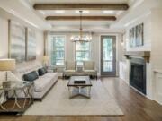 This photo provided by Ashton Woods shows a residential family room with natural wood beams as part of the ceiling in the Ashton Woods GlenPark community in Raleigh, N.C.