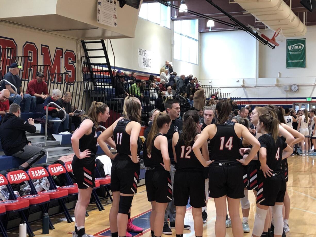 Union girls basketball coach Gary Mills huddles with his team during a 50-36 win over Rogers in a bi-district playoff game Saturday in Tacoma.