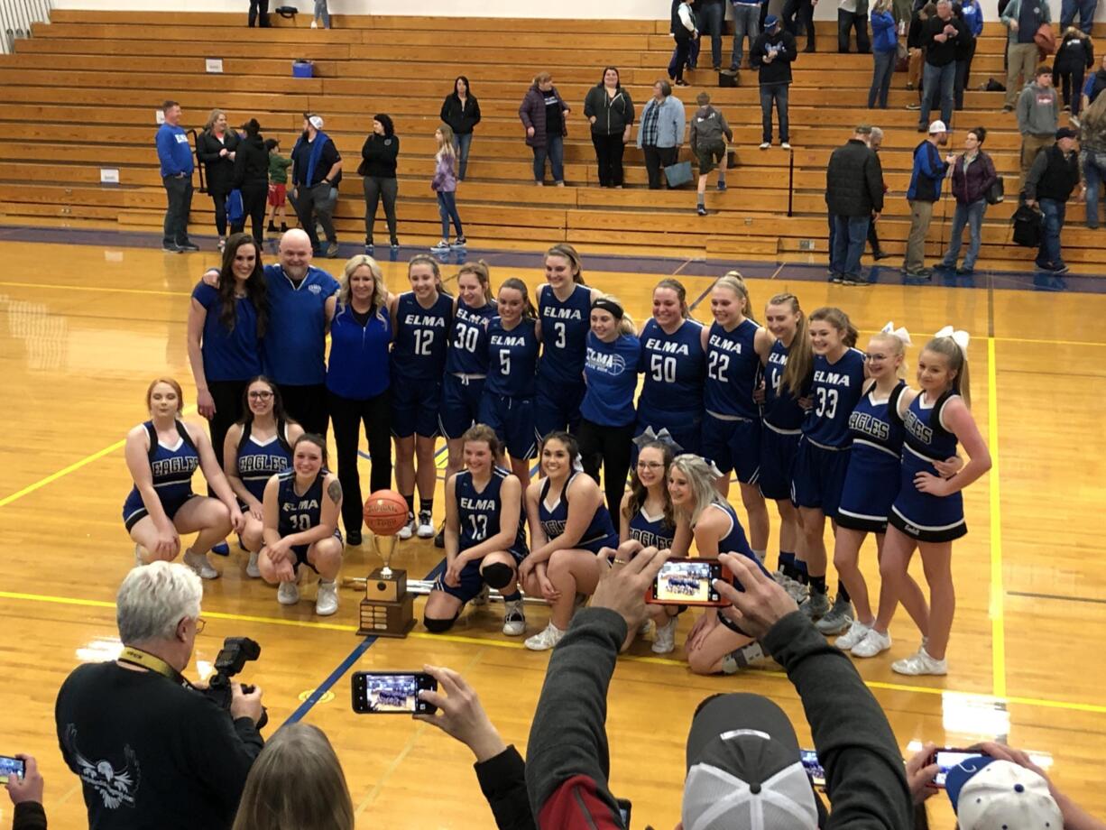 The Elma girls basketball team poses in front of its fans after beating La Center 66-40 in the 1A district championship game Wednesday at Rochester High School.