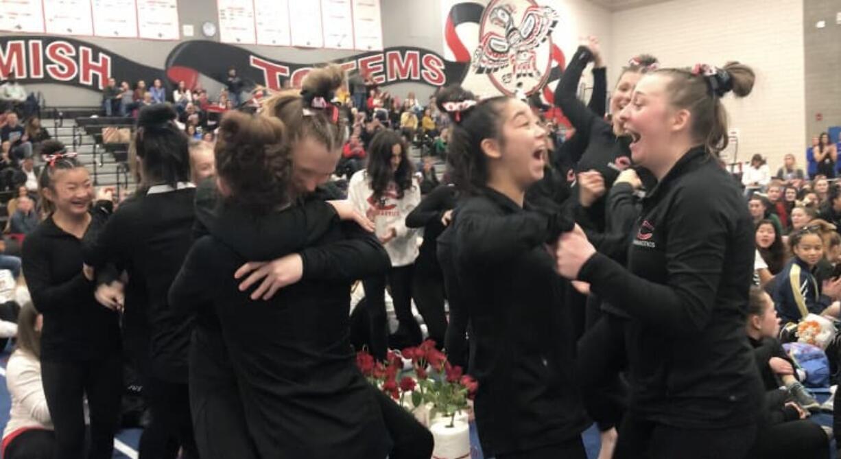 Camas High gymnasts celebrate after winning the WIAA 4A state title on Friday, Feb. 21, 2020, at Sammamish High School. It was their third state championship.