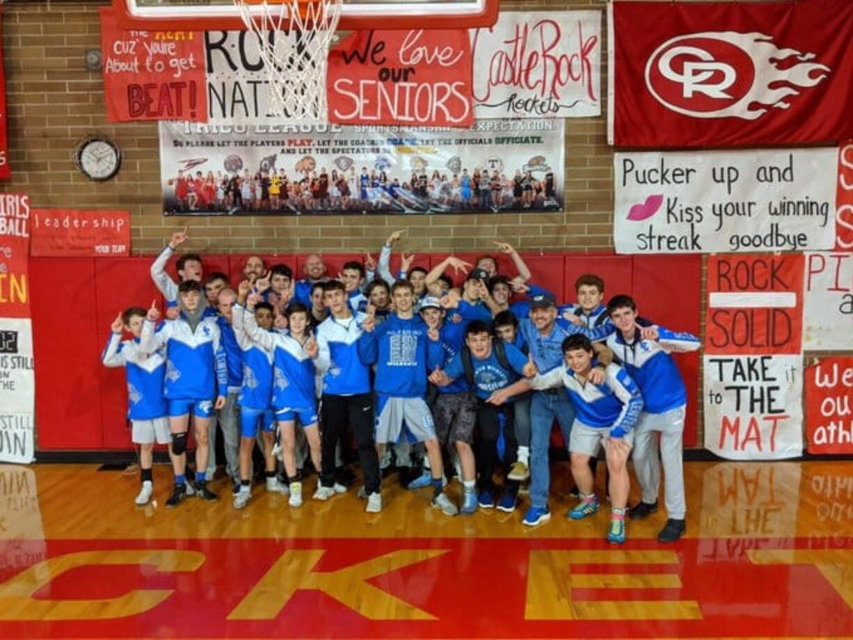 The La Center wrestling team celebrates its 50-28 win over Castle Rock on Tuesday, Jan.