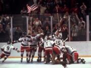 In this Feb. 22, 1980, file photo, the U.S. hockey team pounces on goalie Jim Craig after a 4-3 victory against the Soviet Union in a medal round match at the the 1980 Winter Olympics in Lake Placid, N.Y. The United States upset the mighty Soviets in a breathtaking moment freighted with the tension of the Cold War. After four decades, nobody is willing to stop talking about perhaps the greatest David over Goliath moment in the history of sports.