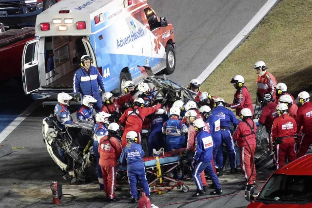 Rescue workers remove Ryan Newman from his car after he was involved in a wreck on the last lap of the NASCAR Daytona 500 auto race at Daytona International Speedway, Monday, Feb. 17, 2020, in Daytona Beach, Fla.