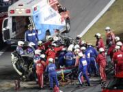 Rescue workers remove Ryan Newman from his car after he was involved in a wreck on the last lap of the NASCAR Daytona 500 auto race at Daytona International Speedway, Monday, Feb. 17, 2020, in Daytona Beach, Fla.