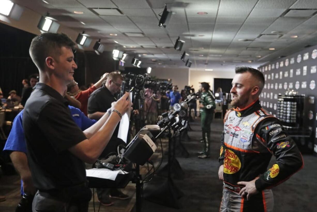 Austin Dillon, right, takes part in an interview during NASCAR Daytona 500 auto racing media day at Daytona International Speedway, Wednesday, Feb. 12, 2020, in Daytona Beach, Fla.