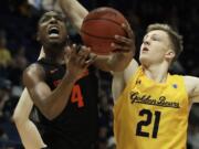 Oregon State&#039;s Alfred Hollins, left, shoots against California&#039;s Lars Thiemann (21) in the second half of an NCAA college basketball game Saturday, Feb. 1, 2020, in Berkeley, Calif.