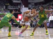 Stanford forward Oscar da Silva (13) dribbles past Oregon guard Anthony Mathis (32) and forward Shakur Juiston (10) during the second half of an NCAA college basketball game Saturday, Feb. 1, 2020, in Stanford, Calif. Stanford won 70-60.