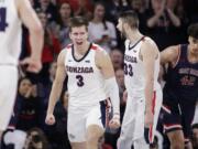 Gonzaga forwards Filip Petrusev (3) and Killian Tillie (33) celebrate after Petrusev scored during the second half of the team's NCAA college basketball game against Saint Mary's in Spokane, Wash., Saturday, Feb. 29, 2020. Gonzaga won 86-76.