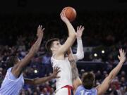 Gonzaga forward Filip Petrusev, center, shoots between San Diego forward James Jean-Marie, left, and forward Alex Floresca during the first half of an NCAA college basketball game in Spokane, Wash., Thursday, Feb. 27, 2020.