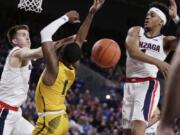 San Francisco guard Jamaree Bouyea, center, has his shot blocked by Gonzaga guard Admon Gilder, right, while also pressured by forward Filip Petrusev during the first half of an NCAA college basketball game in Spokane, Wash., Thursday, Feb. 20, 2020.