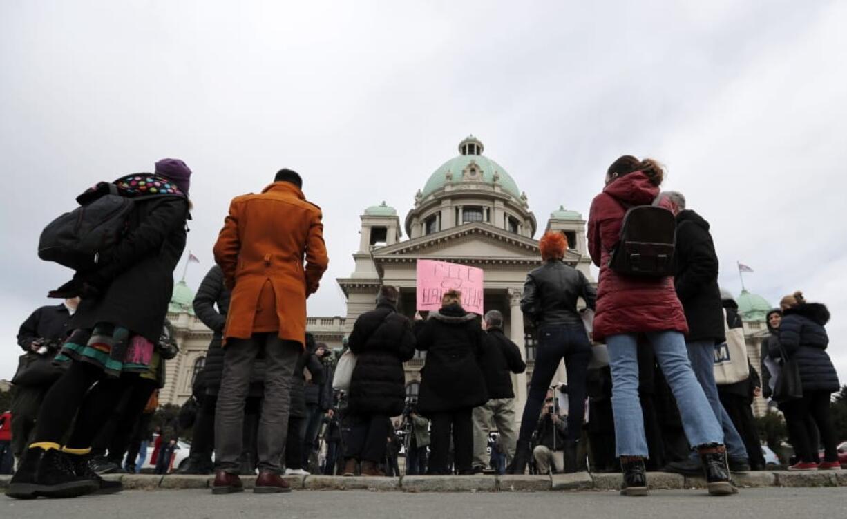 In this photo taken Monday, Feb. 24, 2020, a participant holds a banner that reads: &quot;Where are our Children&quot;, during a protest in front of the parliament building in Belgrade, Serbia.