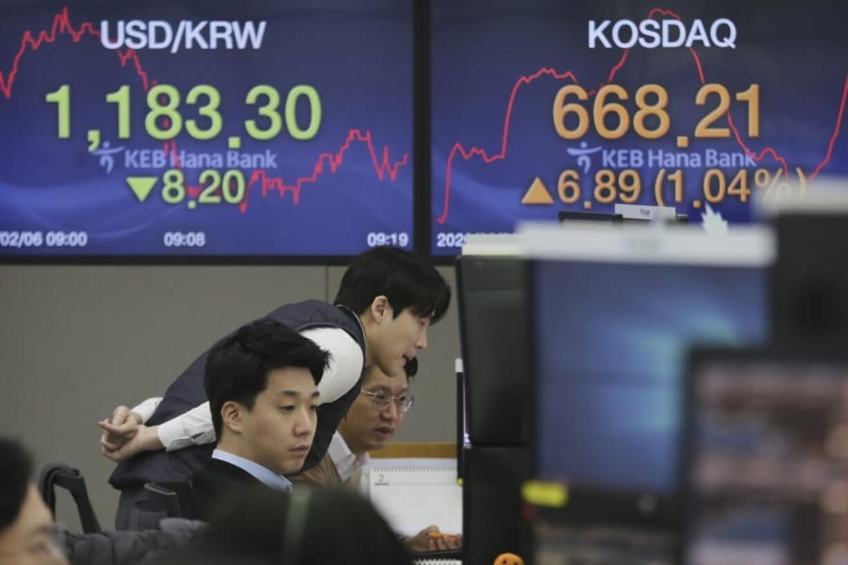 Currency traders watch monitors at the foreign exchange dealing room of the KEB Hana Bank headquarters in Seoul, South Korea, Thursday, Feb. 6, 2020. Asian stock markets have surged after President Donald Trump was acquitted in an impeachment trial and China promised tax cuts and other help to businesses reeling from a virus outbreak.