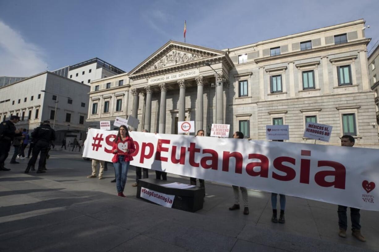 Protesters from the pro-life group Derecho a Vivir stand outside the Spanish parliament in Madrid, Spain, Tuesday, Feb. 11, 2020. Spain&#039;s new parliament is expected to accept in its first legislative session a majority vote the debate on a law that decriminalizes and regulates euthanasia.