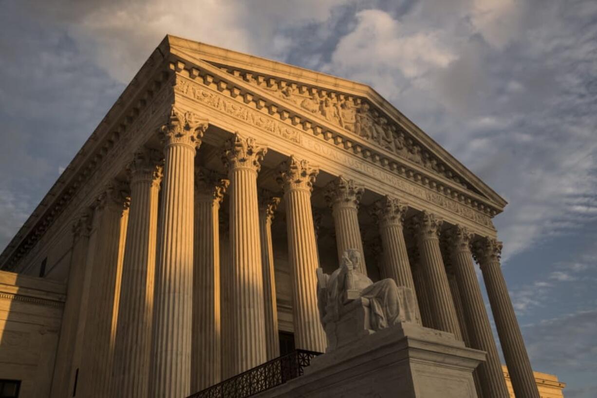 FILE - In this Oct. 10, 2017, file photo, the Supreme Court in Washington, at sunset. The Supreme Court is hearing arguments March 2, 2020, to decide whether Vijayakumar Thuraissigiam can be deported without getting to make his asylum case to a federal judge. (AP Photo/J.