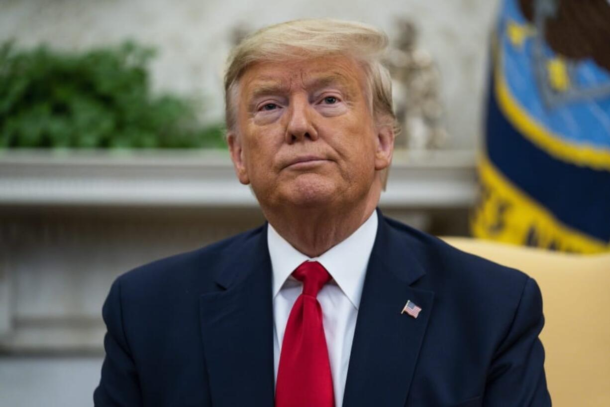 President Donald Trump listens to a question during a meeting with Ecuadorian President Lenin Moreno in the Oval Office of the White House, Wednesday, Feb. 12, 2020, in Washington.