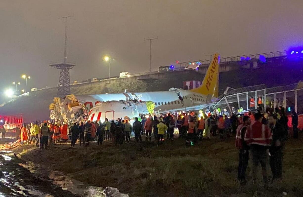 Rescue members and firefighters work after a plane skidded off the runway at Istanbul&#039;s Sabiha Gokcen Airport, in Istanbul, Wednesday, Feb. 5, 2020. The plane skidded off the runway, crashing into a field and breaking into pieces. Authorities said at least 52 people were injured, and passengers were seen evacuating through the cracks in the plane.