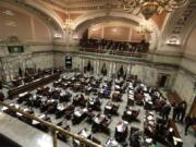 Lawmakers work on the Senate floor Wednesday, Feb. 19, at the Capitol in Olympia.