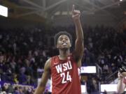 Washington State's Noah Williams points toward the stands after Washington State defeated Washington 78-74 in an NCAA college basketball game Friday, Feb. 28, 2020, in Seattle.