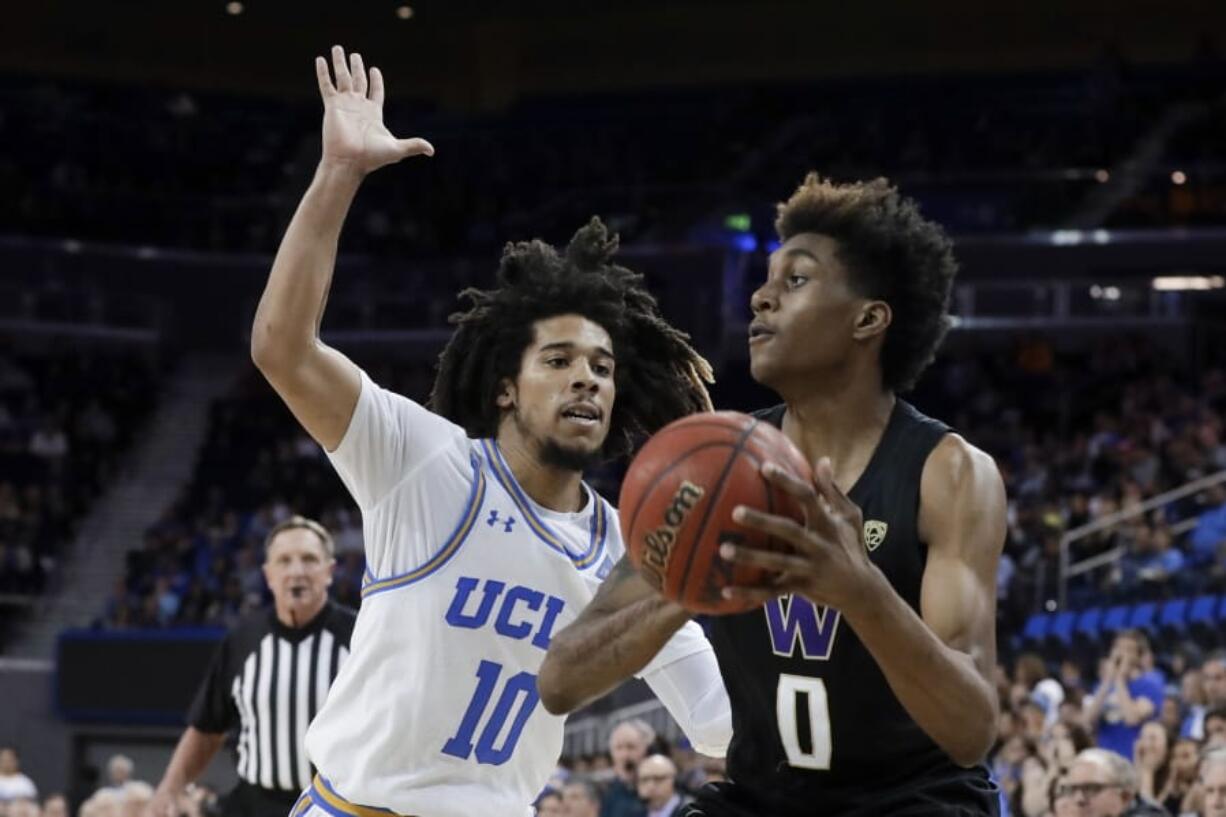 Washington forward Jaden McDaniels shoots around UCLA guard Tyger Campbell during the second half of an NCAA college basketball game in Los Angeles, Saturday, Feb. 15, 2020.