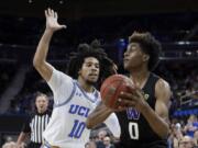 Washington forward Jaden McDaniels shoots around UCLA guard Tyger Campbell during the second half of an NCAA college basketball game in Los Angeles, Saturday, Feb. 15, 2020.