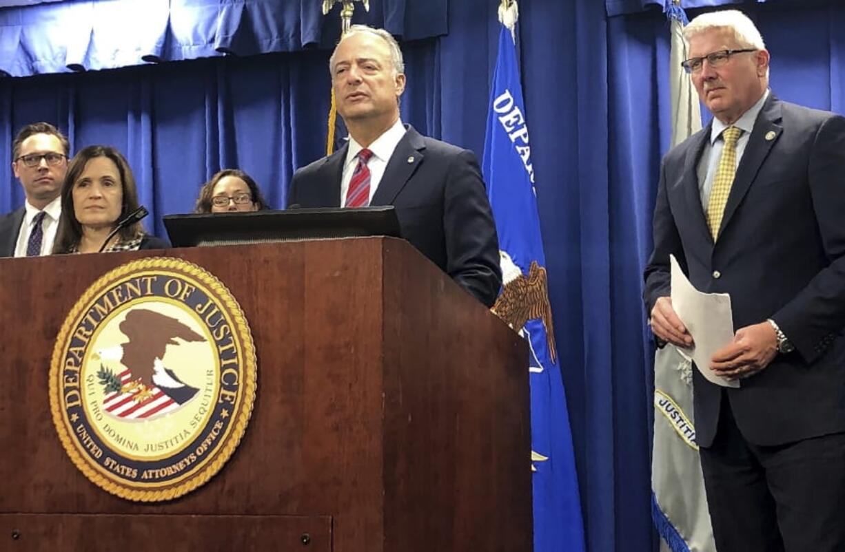 Nicola T. Hanna, U.S. Attorney for the Central District of California, at podium, announces at a news conference in Los Angeles Friday, Feb. 21, 2020, that Wells Fargo has agreed to pay $3 billion to settle criminal and civil investigations into a long-running practice whereby company employees opened millions of unauthorized bank accounts in order to meet unrealistic sales goals.