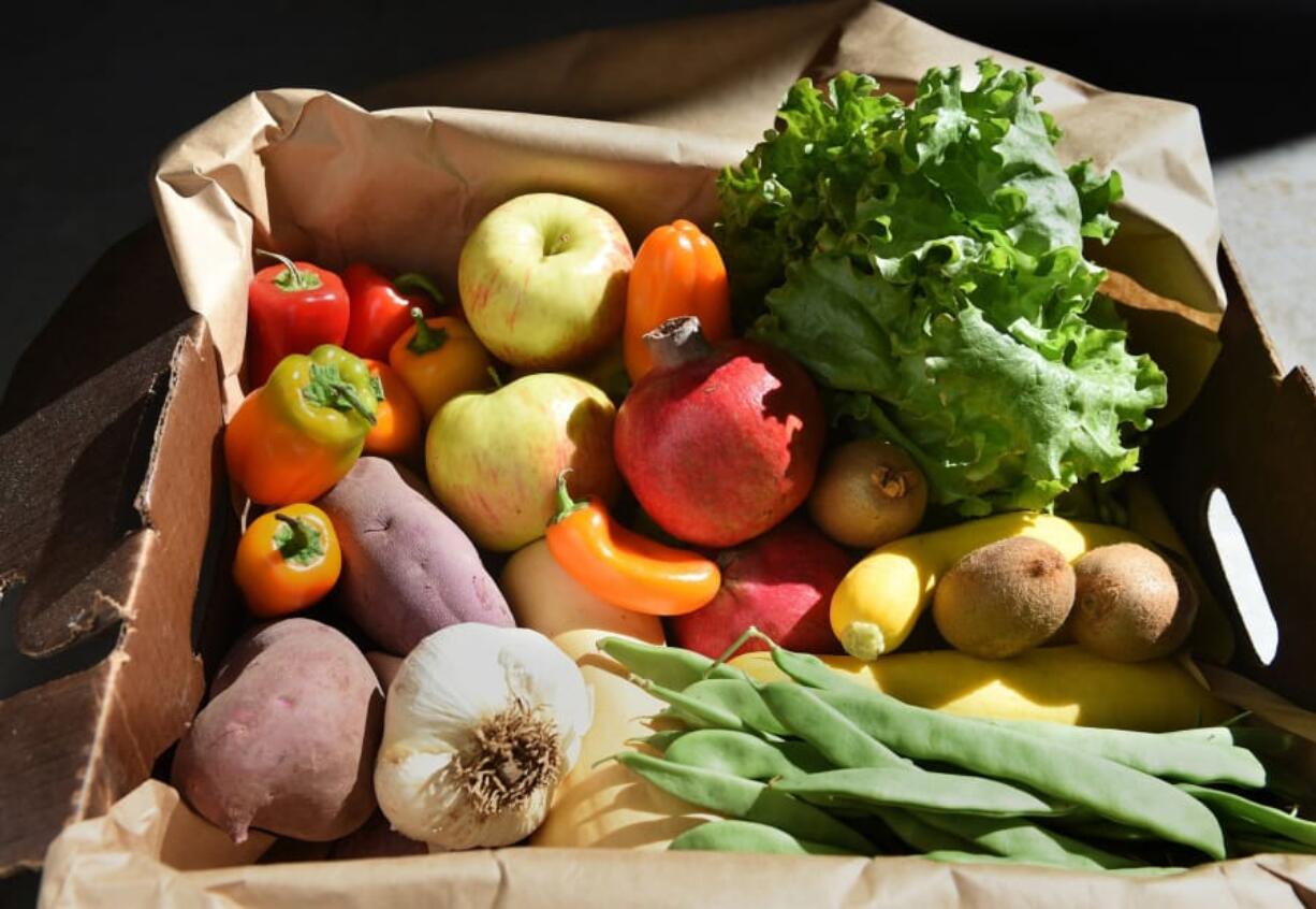 A box of produce from Harvest Fields Organic Farm. If we slashed food waste and raising livestock and eating meat, organic agriculture could go worldwide, proponents say.