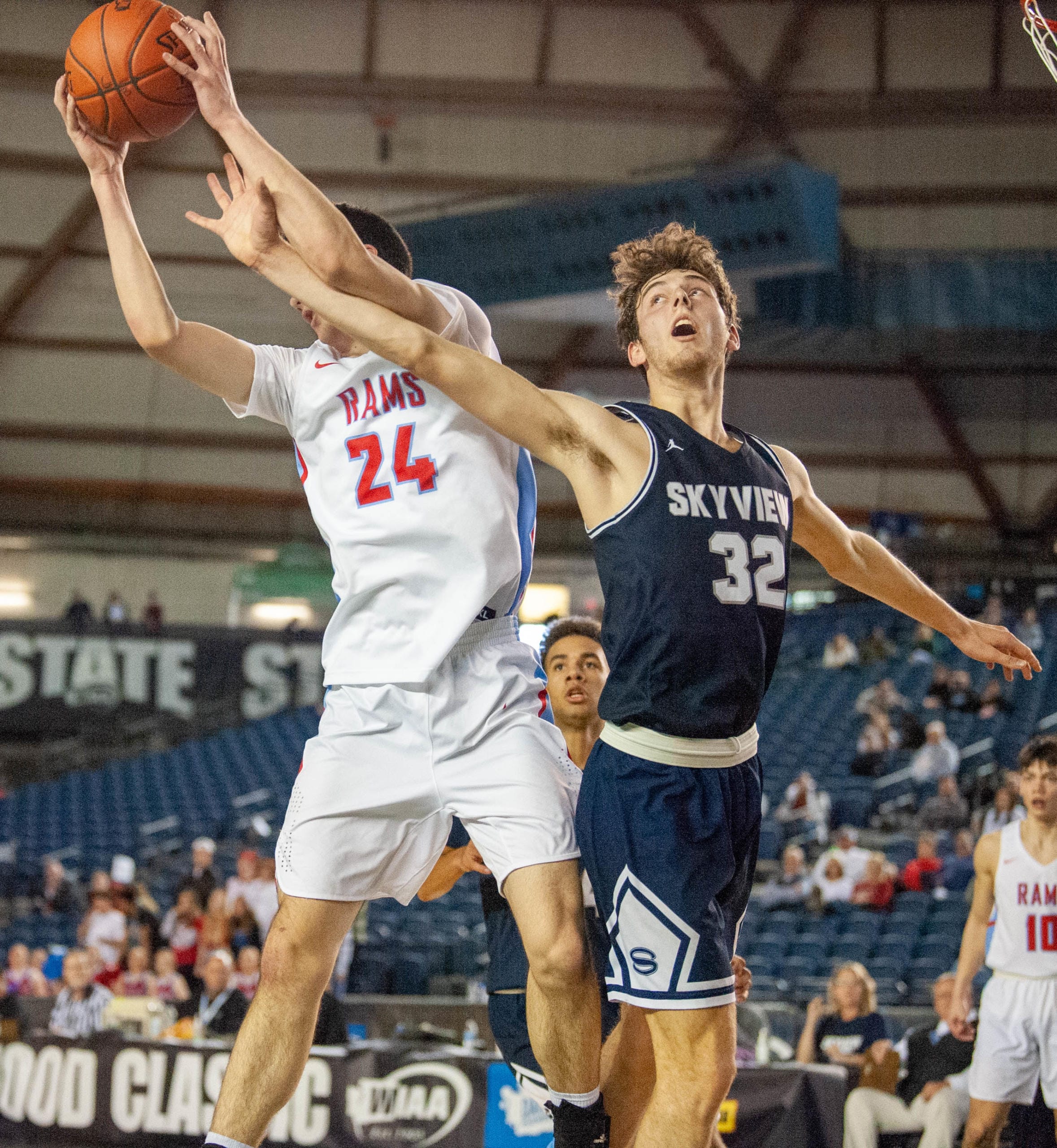 Skyview's Cody McKinney and West Valley's Logan Kinloch fight for a rebound in a 4A State round-of-12 game Wednesday at the Tacoma Dome.