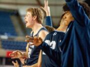 Skyview's Cole Bain, left, celebrates a Jace Chatman 3-pointer with his teammates on the bench during Skyviews' 47-31 victory over West Valley of Yakima in a 4A round-of-12 game Wednesday at the Tacoma Dome.