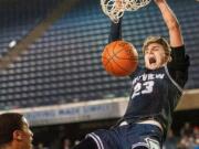 Skyview's Kyle Gruhler slams home a dunk in a 4A State quarterfinal on Thursday at the Tacoma Dome.  The Storm lost 65-64.