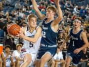 Union's Tanner Toolson drives past Olympia's Jackson Grant in a 4A State quarterfinal game on Thursday at the Tacoma Dome. Union won 69-56.