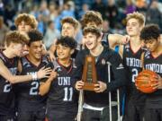 Union players, from left to right (front row) Kaden Horn, Jamison Limbrick, Izaiah Vongnath, Tanner Toolson and Ariya Briscoe celebrate their third-place trophy on Saturday at the Tacoma Dome.