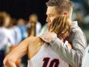 Union coach Gary Mills comforts Lolo Weatherspoon after the Titans' 47-45 defeat in a 4A State third-place game Saturday at the Tacoma Dome.