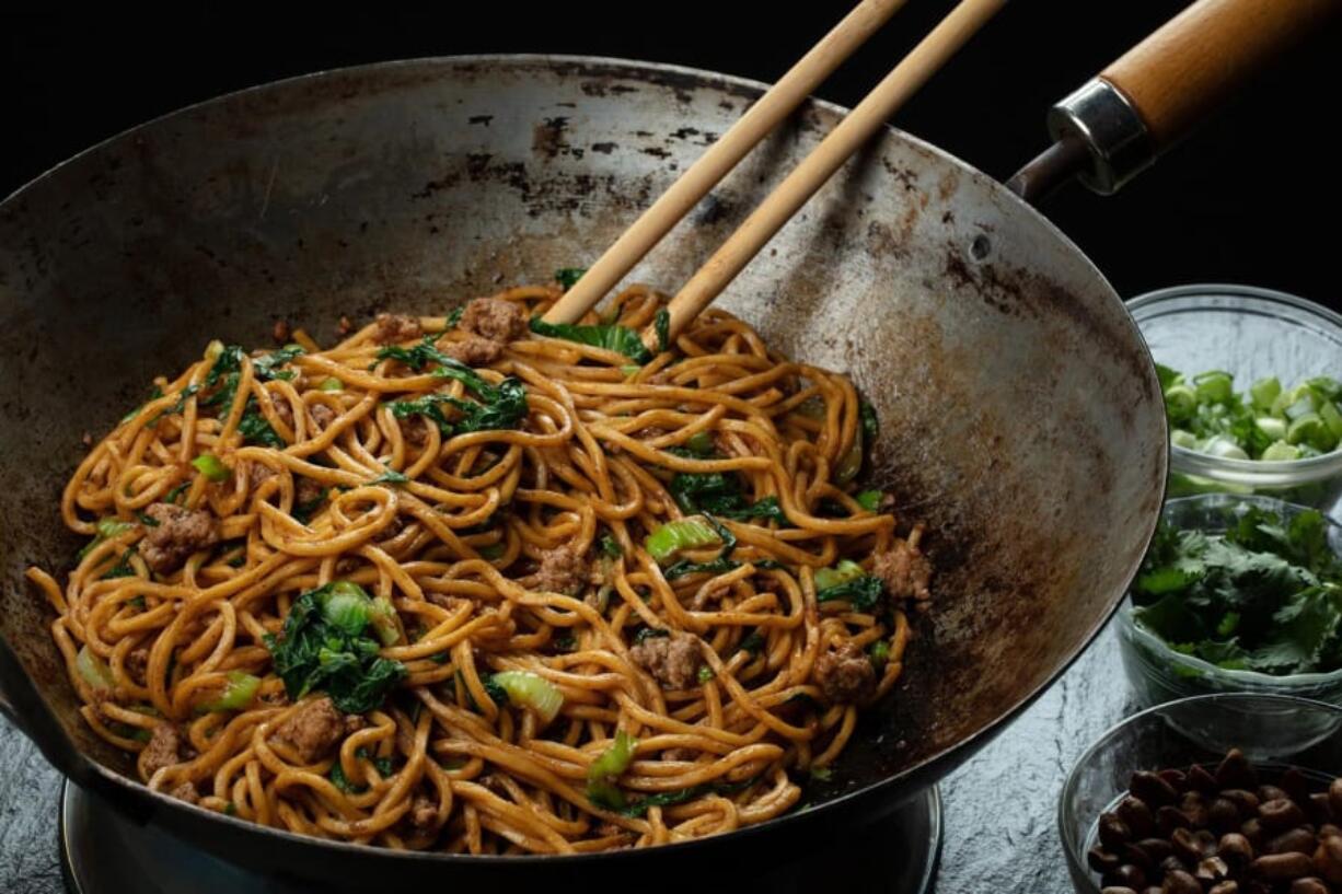 Noodles are tossed in an oil flavored with Sichuan peppercorns, then finished with peanuts, green onions, cilantro, garlic and more peppercorns but this time ground into a powder. (E.