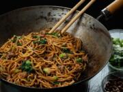 Noodles are tossed in an oil flavored with Sichuan peppercorns, then finished with peanuts, green onions, cilantro, garlic and more peppercorns but this time ground into a powder. (E.