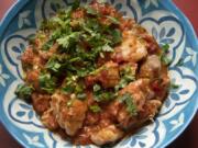 Kenyan coconut chicken is made with tomatoes and coconut milk and flavored with ginger, garlic and ground coriander.