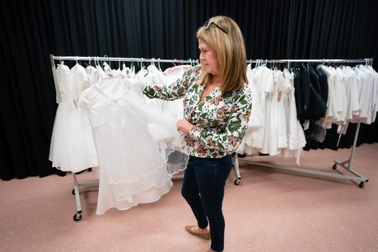 Colleen Sharp shows the &quot;Communion Closet&quot; at St. Katherine of Sienna Church, where families can check out slightly used communion outfits, March 9 in Philadelphia, Pa.