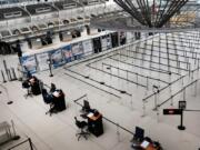 People walk through a sparse international departure terminal at John F. Kennedy Airport as concern over the coronavirus grows on March 7 in New York City, N.Y.