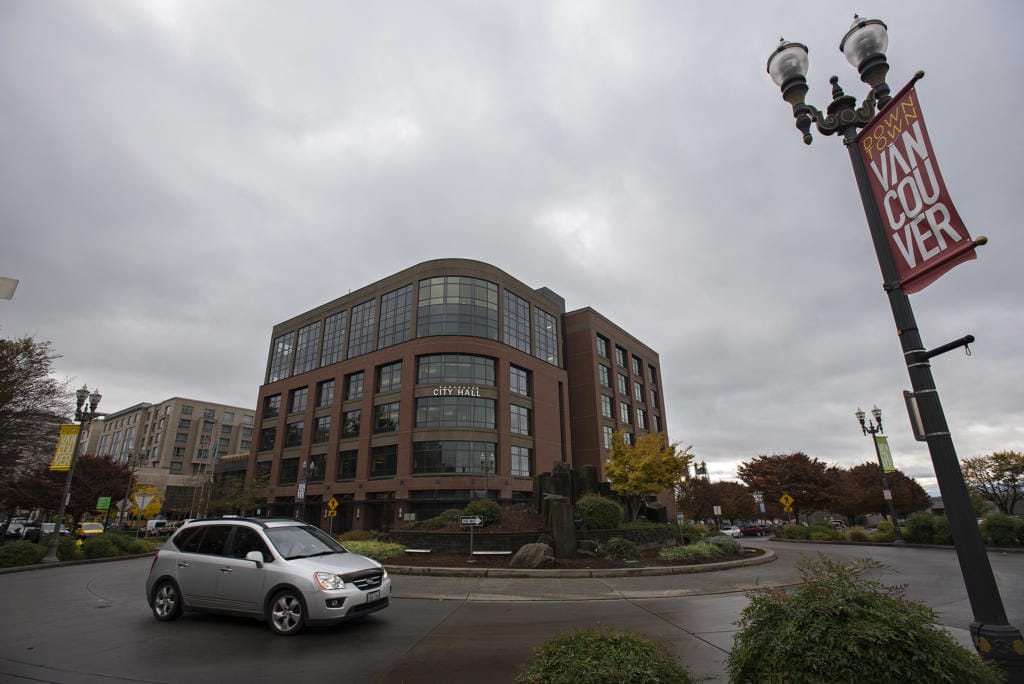 A motorist navigates a roundabout near Vancouver City Hall.