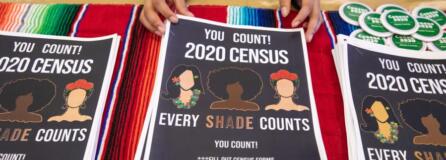 Alma Melchor, 17, a volunteer with the Southwest Washington Census Coalition, straightens a stack of information packets while working at a table at Expo Quinceanera NW on Feb. 29, 2020.