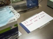 A sign directing visitors to the front desk if they are in need of a mask is seen at PeaceHealth Southwest Medical Center in Vancouver.