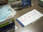 A sign directing visitors to the front desk if they are in need of a mask is seen here at PeaceHealth Southwest Medical on Monday afternoon, March, 2, 2020.