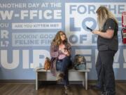 Cheryl Collins, left, and her daughter&#039;s cat Barney check in with Clinic Assistant Nicole Akerill at the VetIQ location inside the 221E N.E. 104th Ave. Walmart in Vancouver.