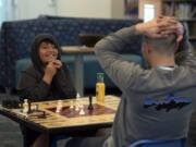 Luis, 10, reacts as he wins a game of chess against his mentor, Brian Kay, on Wednesday at Cascade Park Community Library in Vancouver. The duo were paired through Friends of the Children, a mentoring program that started in Portland in 1993.