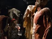 Warrenton Grade School seventh-grader Daniel Ulness looks up at a skinless man who&#039;s holding up his own skin -- the heaviest of all human organs -- in the &quot;Body Worlds&quot; exhibit at OMSI.